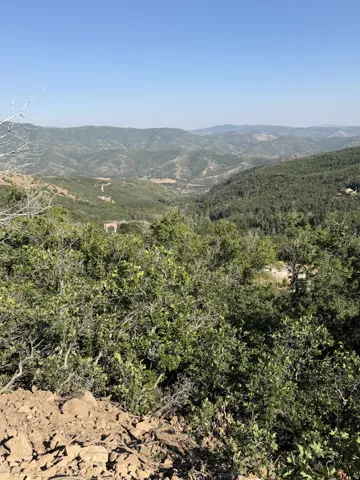 Views from the lot,  Expansive mountain valley landscape with distant peaks and dense forestation