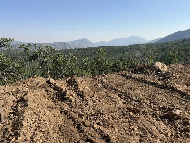 Mountain view backdrop with distant peaks and expansive forested terrain