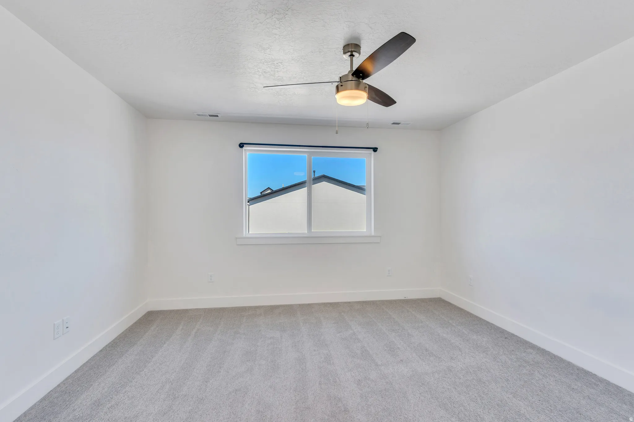 Bright interior space featuring a ceiling fan with integrated lighting