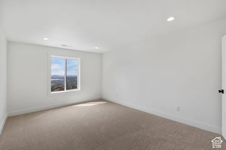 Bright room with neutral carpet flooring and white walls
