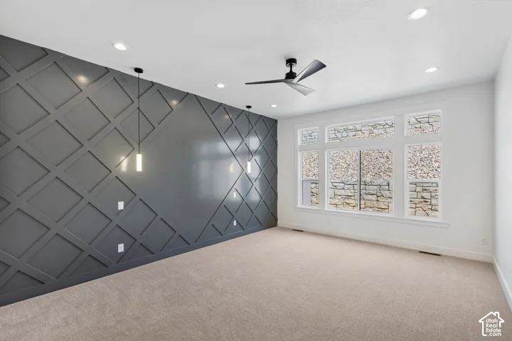 Accent wall featuring geometric paneling and a dark finish, complemented by three pendant lights