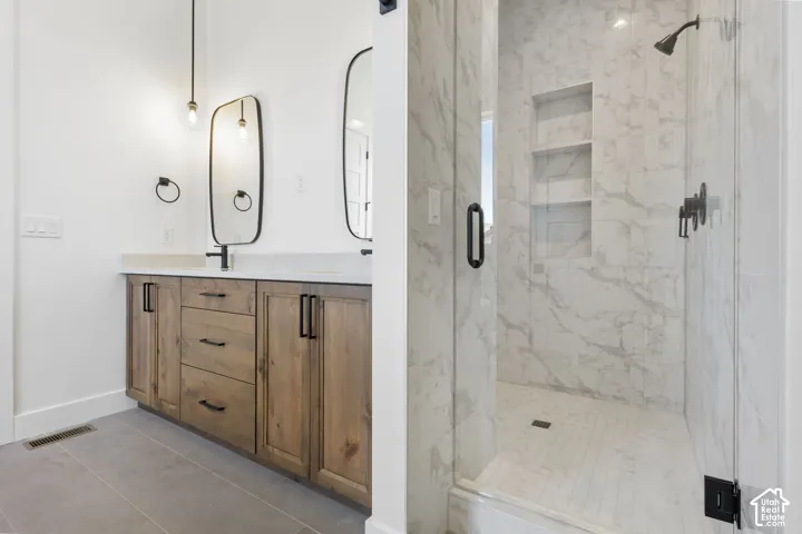 Modern bathroom featuring a wood-finish double vanity with white countertop, dual black-framed mirrors, and matte black fixtures