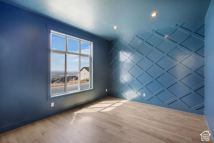 Expansive window framing distant scenery, complemented by a unique geometric accent wall