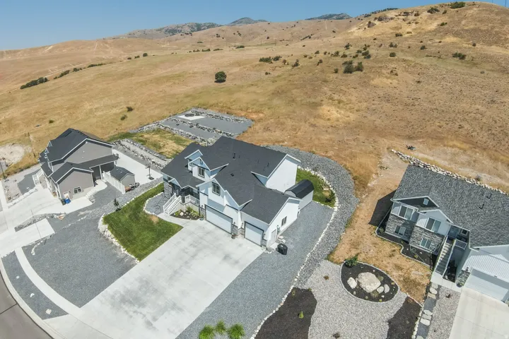 Contemporary two-story residence featuring a striking light blue and white exterior with dark gray roofing