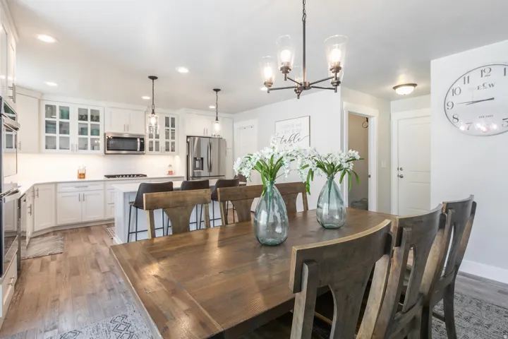 Open-concept kitchen and dining area featuring light wood-finish flooring