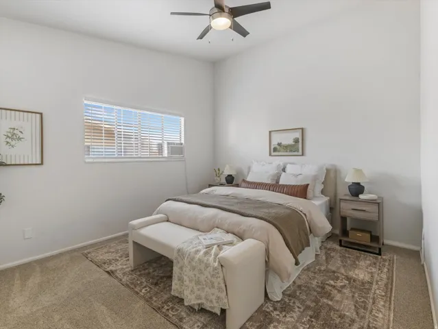 Bedroom featuring a vaulted ceiling and a ceiling fan with integrated lighting