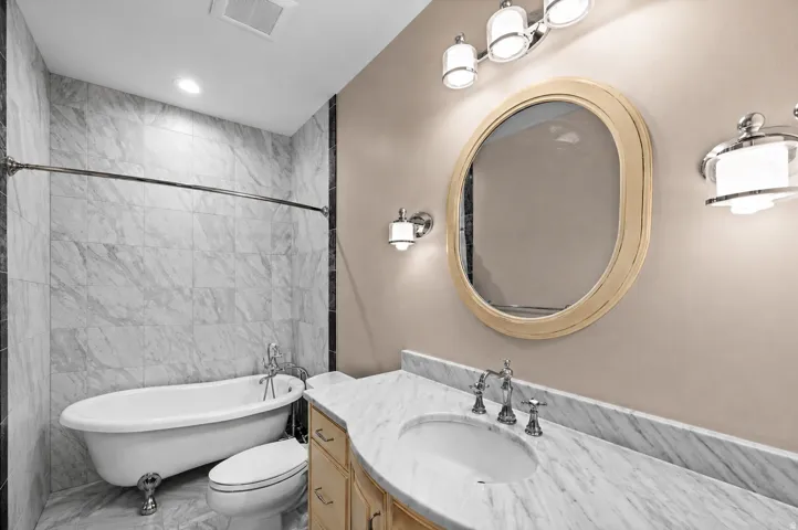Featuring a classic clawfoot tub, this elegant bathroom offers a true spa-like retreat.