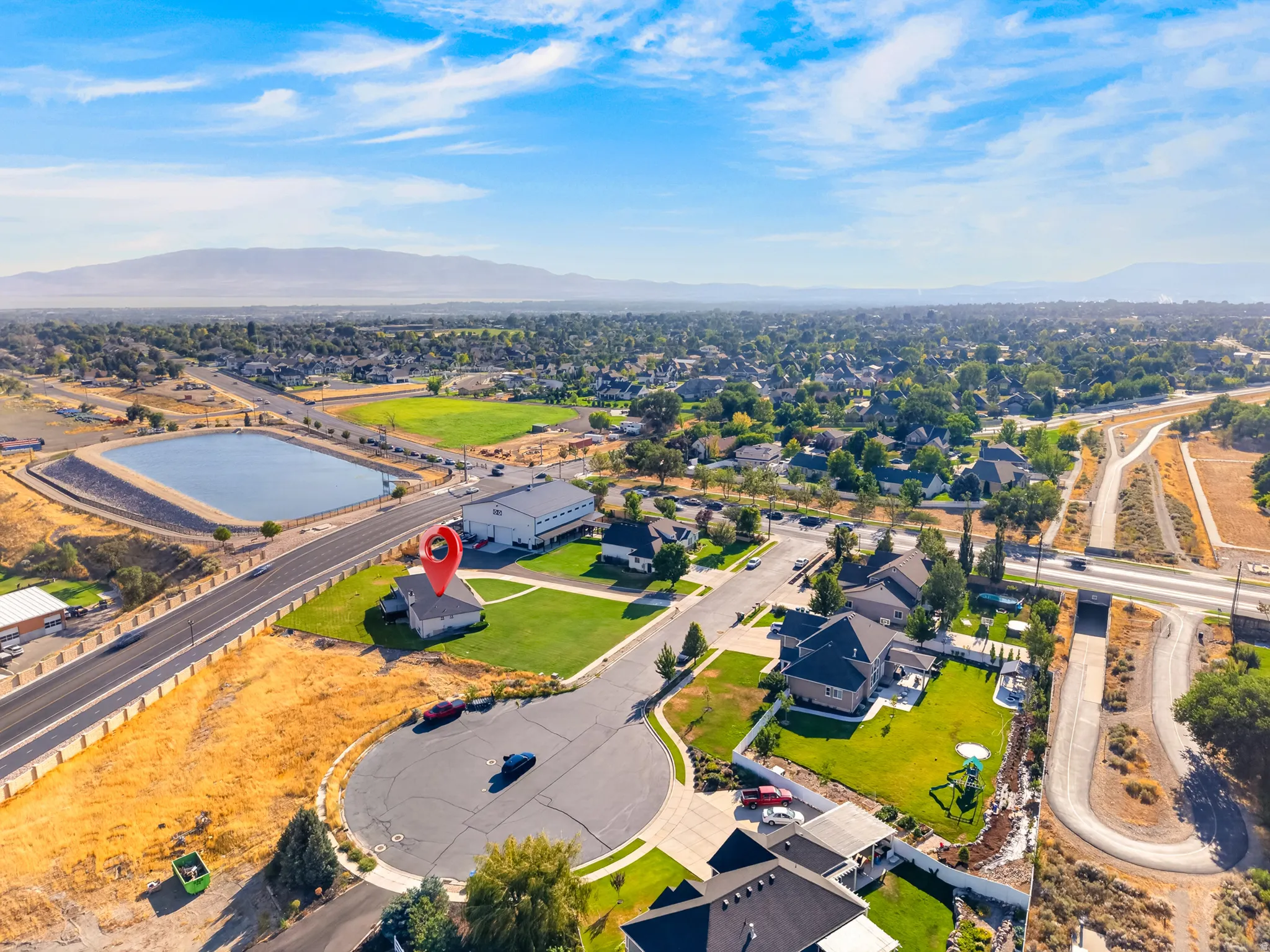 Aerial perspective showcasing a cul-de-sac property with surrounding residential areas and distant mountainous terrain