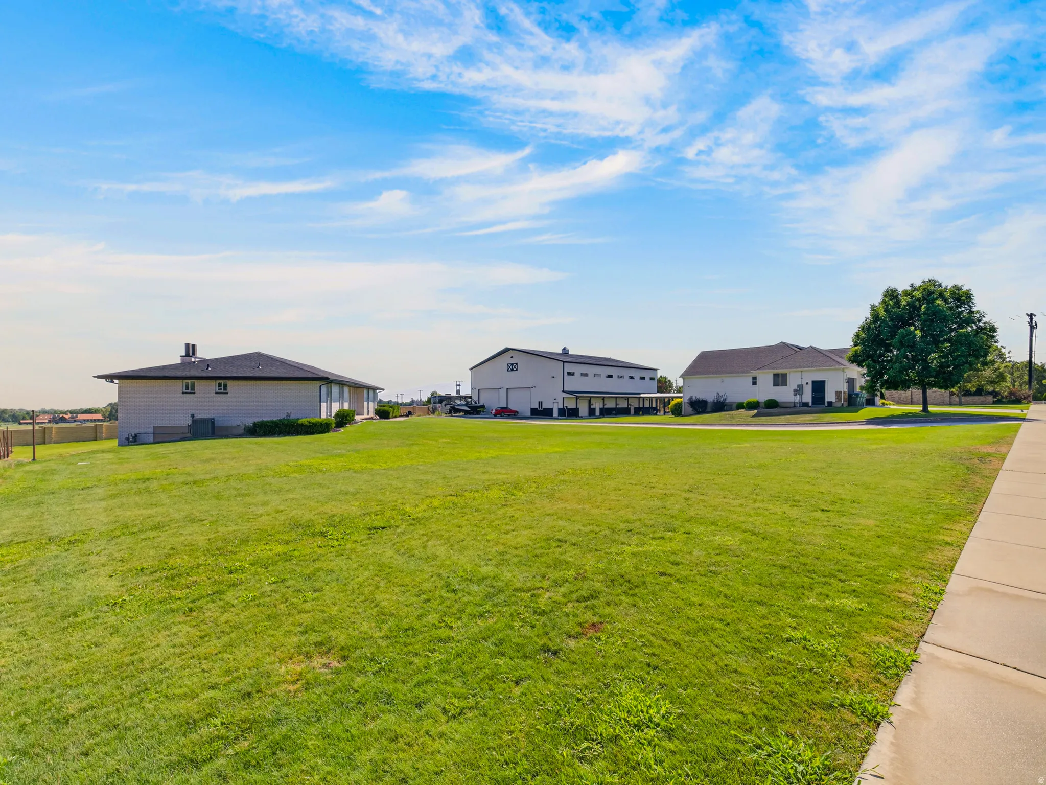 Expansive green lawn with sidewalk access
