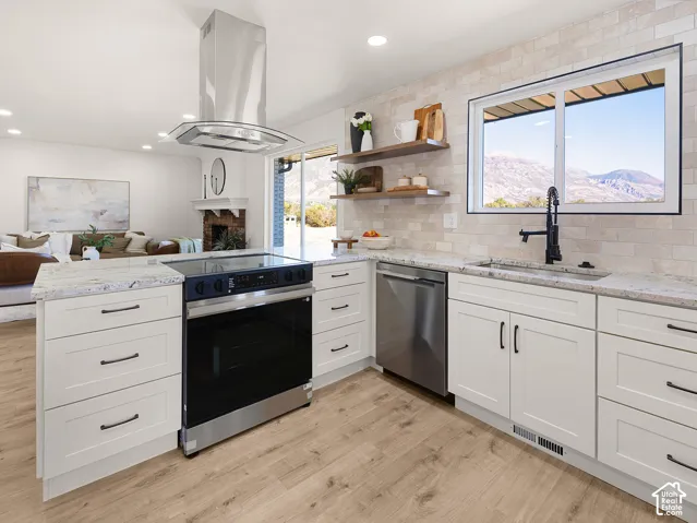 Kitchen featuring white shaker-style cabinetry, light-toned granite countertops, and wood-finish flooring