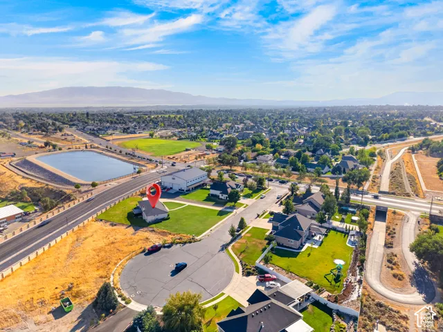 Aerial perspective showcasing a cul-de-sac property with surrounding residential areas and distant mountainous terrain