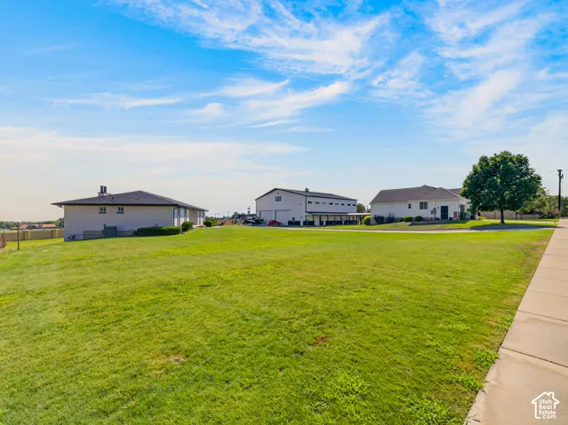 Expansive green lawn with sidewalk access