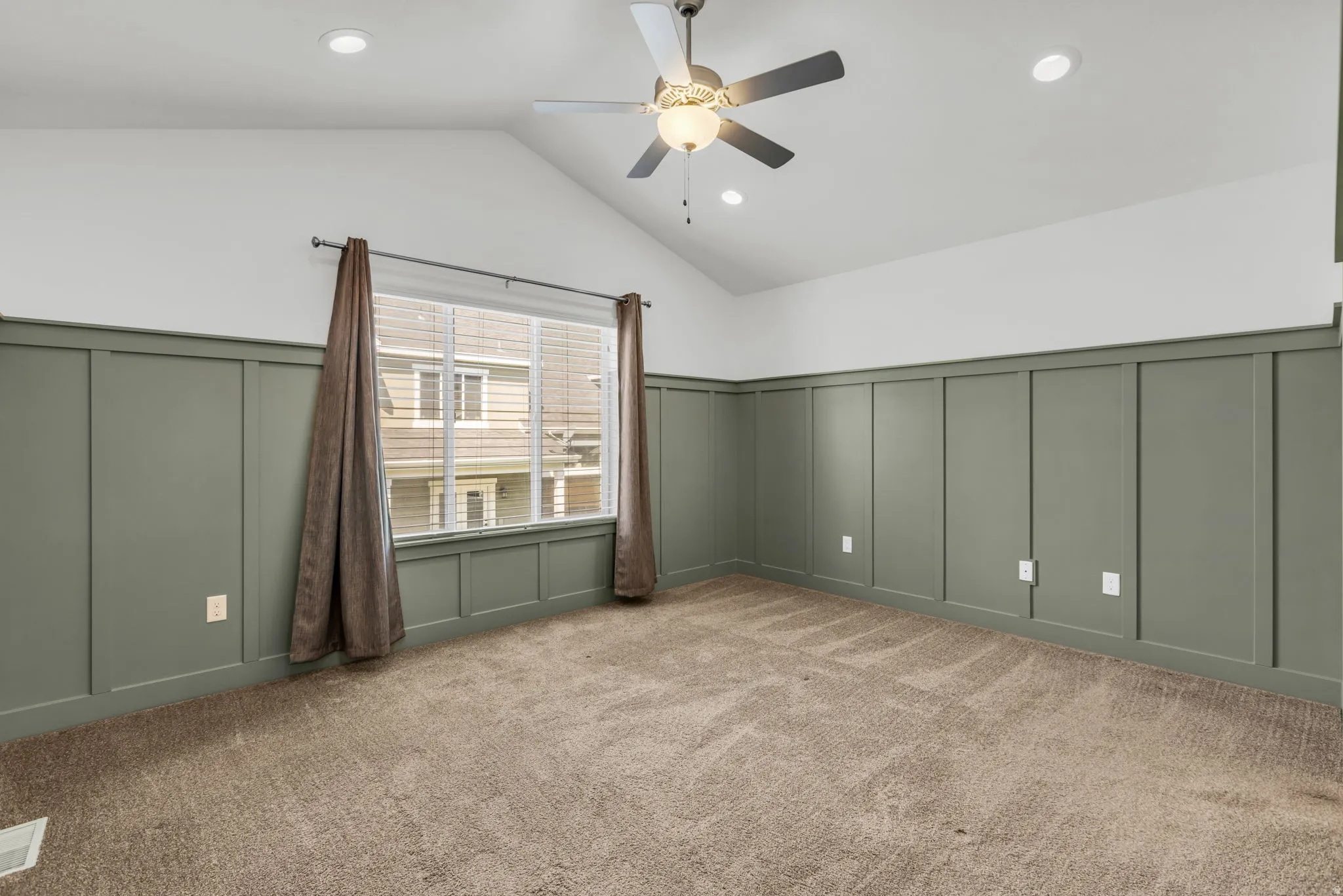 Vaulted ceilings with recessed lighting and a ceiling fan