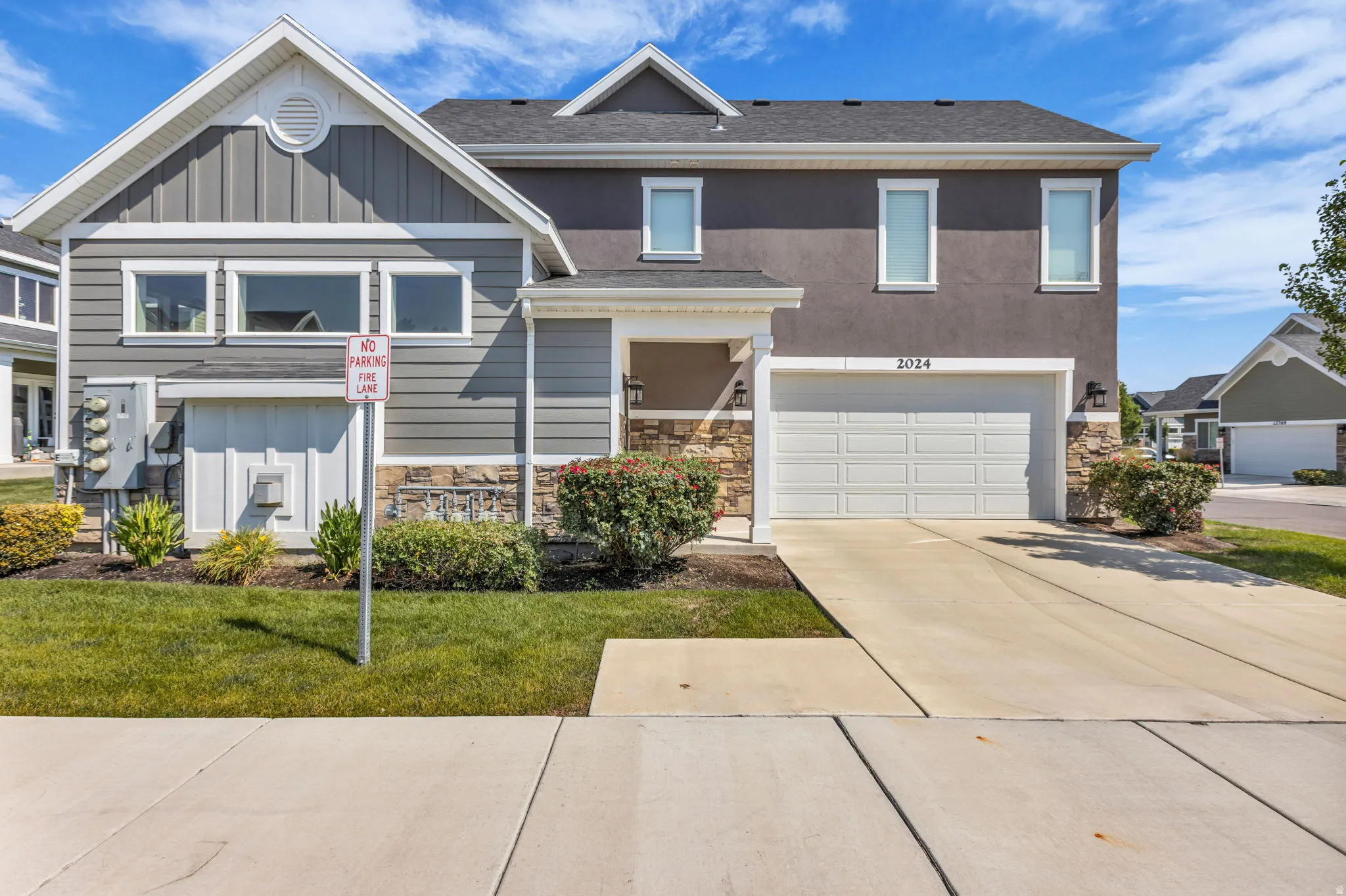 Contemporary facade featuring mixed siding and stone accents