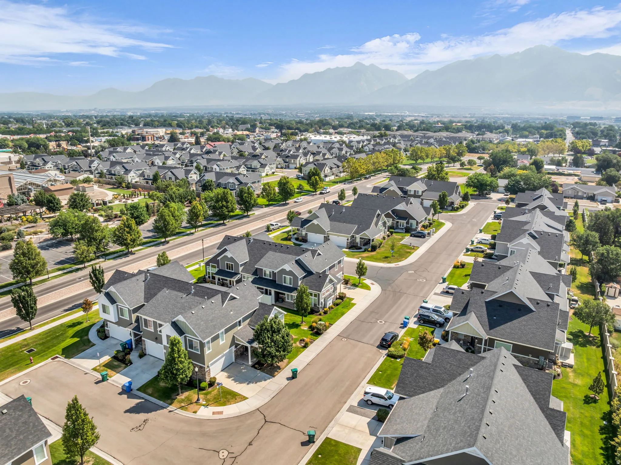 Aerial perspective showcasing a residential community with uniform architectural styles and mature landscaping