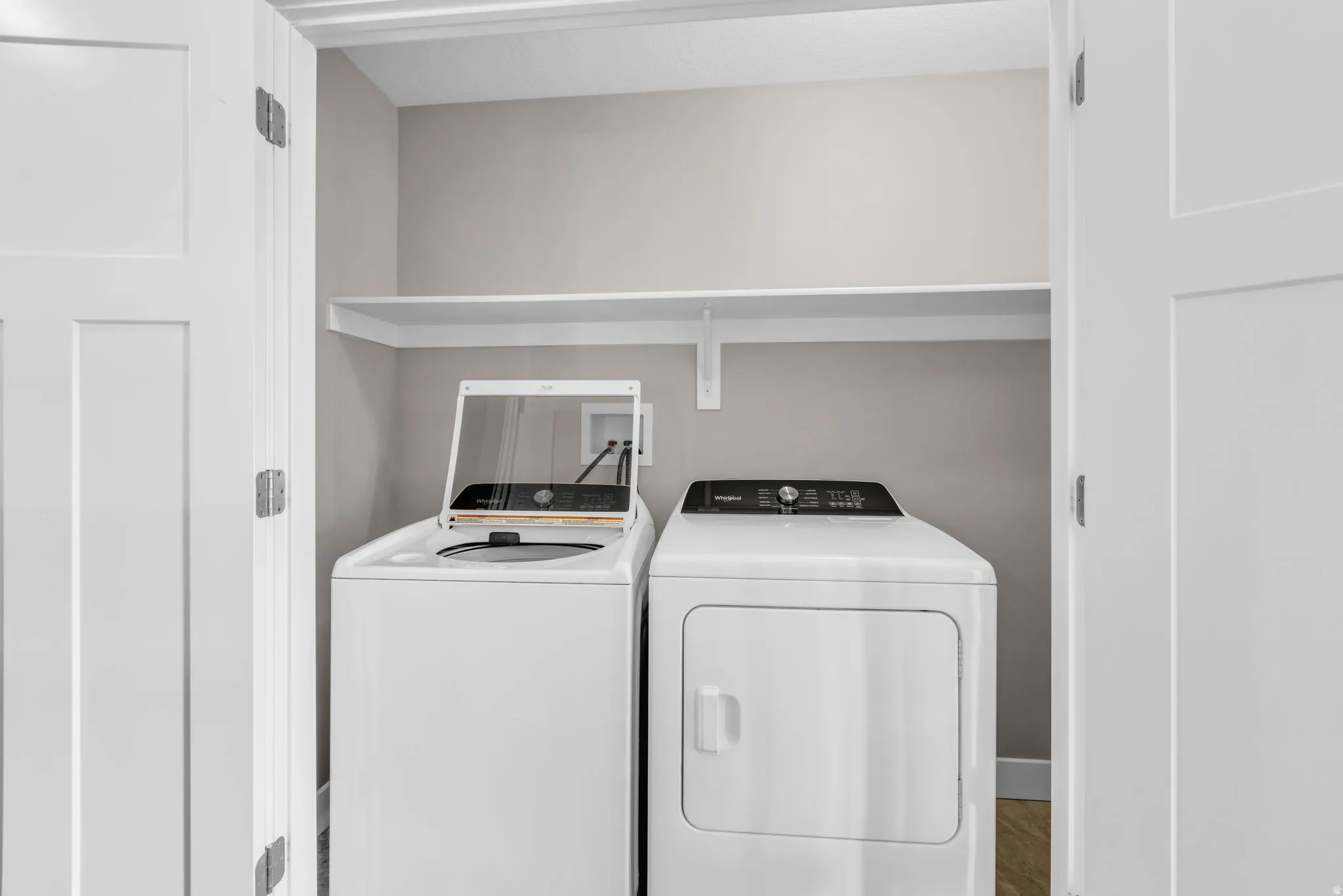 Dedicated laundry closet featuring a top-load washer and front-load dryer