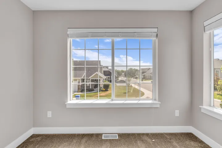 Expansive window with white grilles and integrated blinds