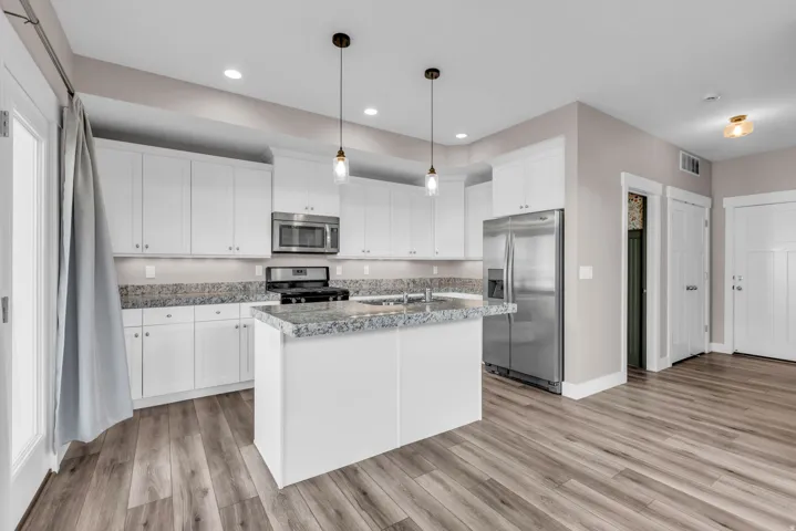 Modern kitchen with extensive white cabinetry and stainless steel appliances