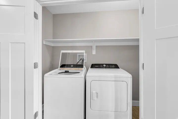 Dedicated laundry closet featuring a top-load washer and front-load dryer