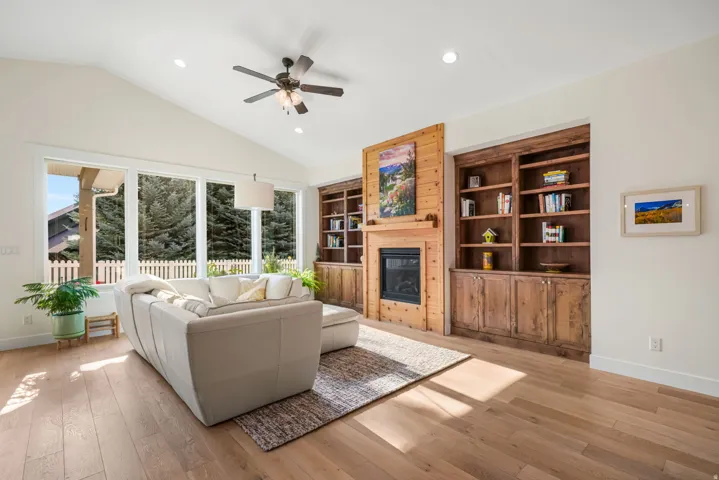 Living area featuring a vaulted ceiling and wood-finish flooring