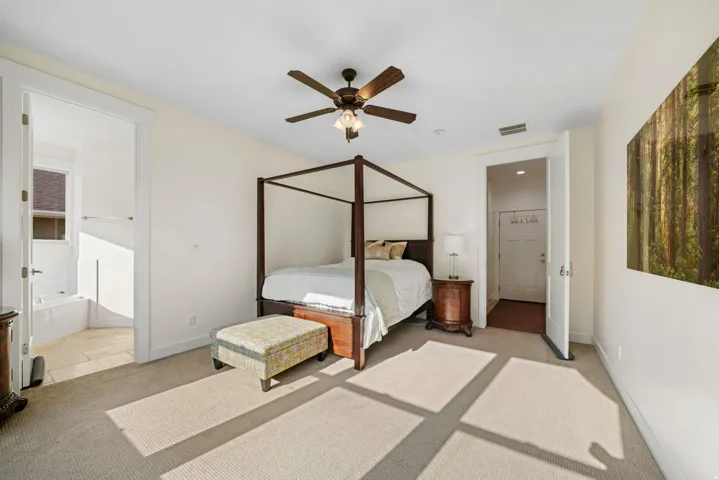 Carpeted room featuring a ceiling fan with integrated lighting, white walls, and a recessed window