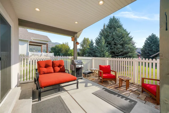 Covered patio featuring recessed lighting, a concrete pad, and a stone paver section