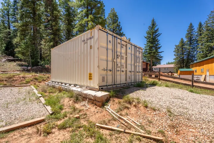 White shipping container structure on a gravel base