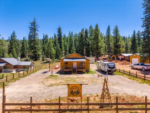 Rustic ranch compound featuring multiple outbuildings and structures set on expansive grounds