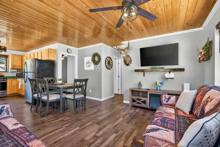 Open-concept living space featuring wood-finish flooring and a wood plank ceiling