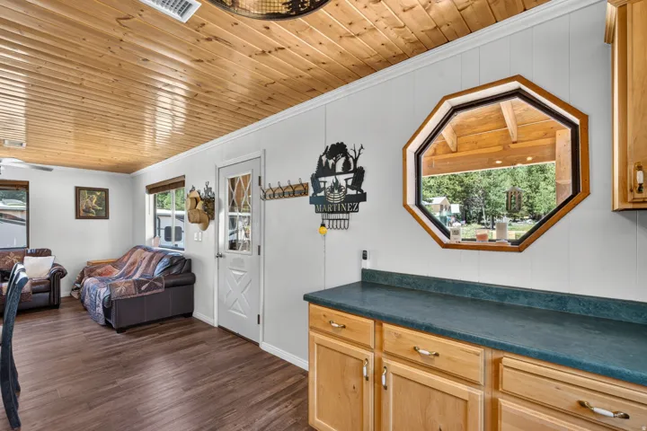 Wood-finish flooring throughout, complemented by a wood-paneled ceiling