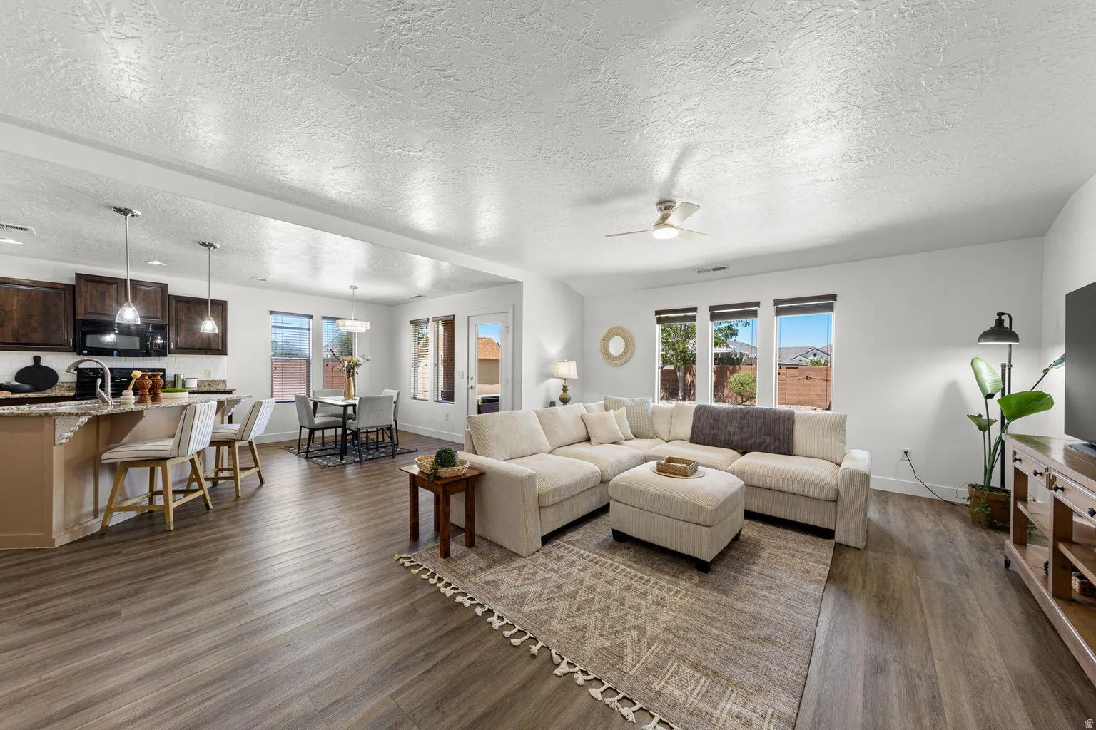 Open-concept living space featuring wood-finish flooring throughout