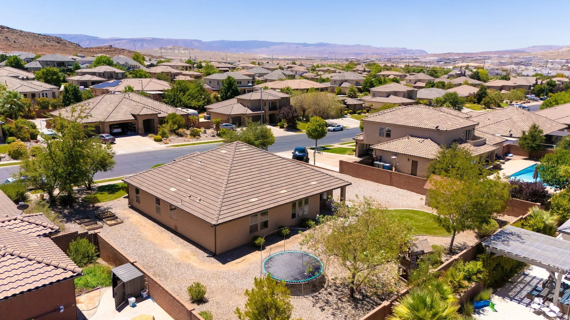 Aerial perspective highlighting the property's tile roof and stucco exterior