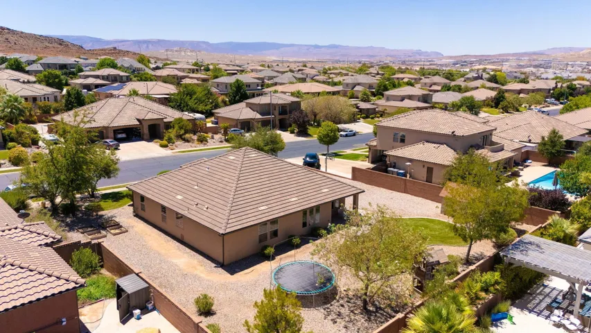 Aerial perspective highlighting the property's tile roof and stucco exterior