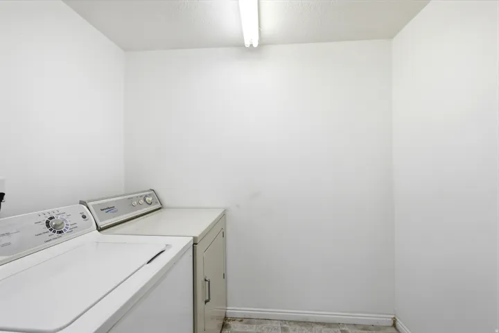 Dedicated laundry area featuring white walls and patterned flooring