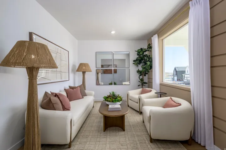 Well-lit living area featuring abundant natural light, recessed lighting, and a neutral color palette