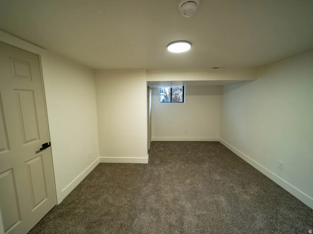 Spacious room featuring new carpeting, fresh paint, a built-in window, and recessed lighting