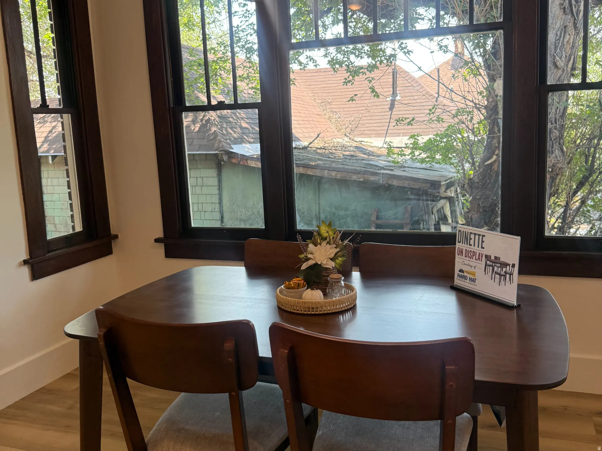 Dining area featuring wood-finish flooring and extensive dark wood trim