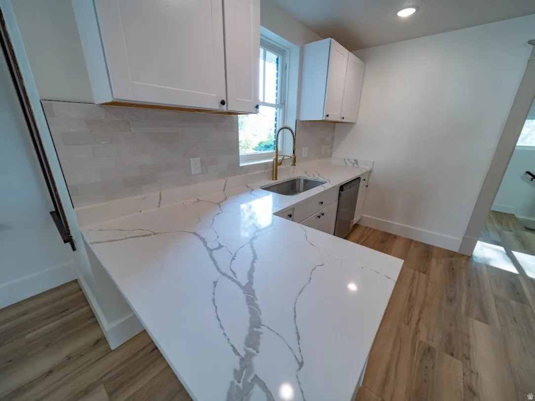 L-shaped countertop with pronounced veining, complemented by white shaker cabinetry and a subway tile backsplash