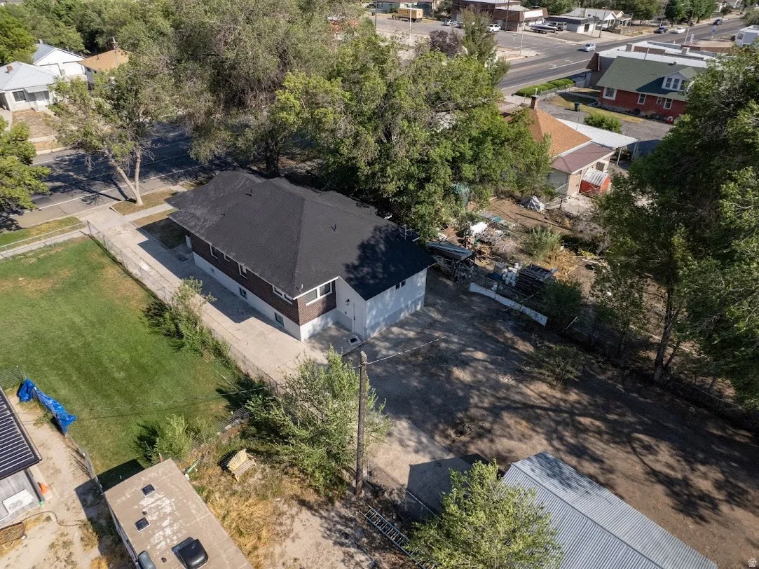 Two-story residence featuring a dark shingle roof, brown siding, and white trim