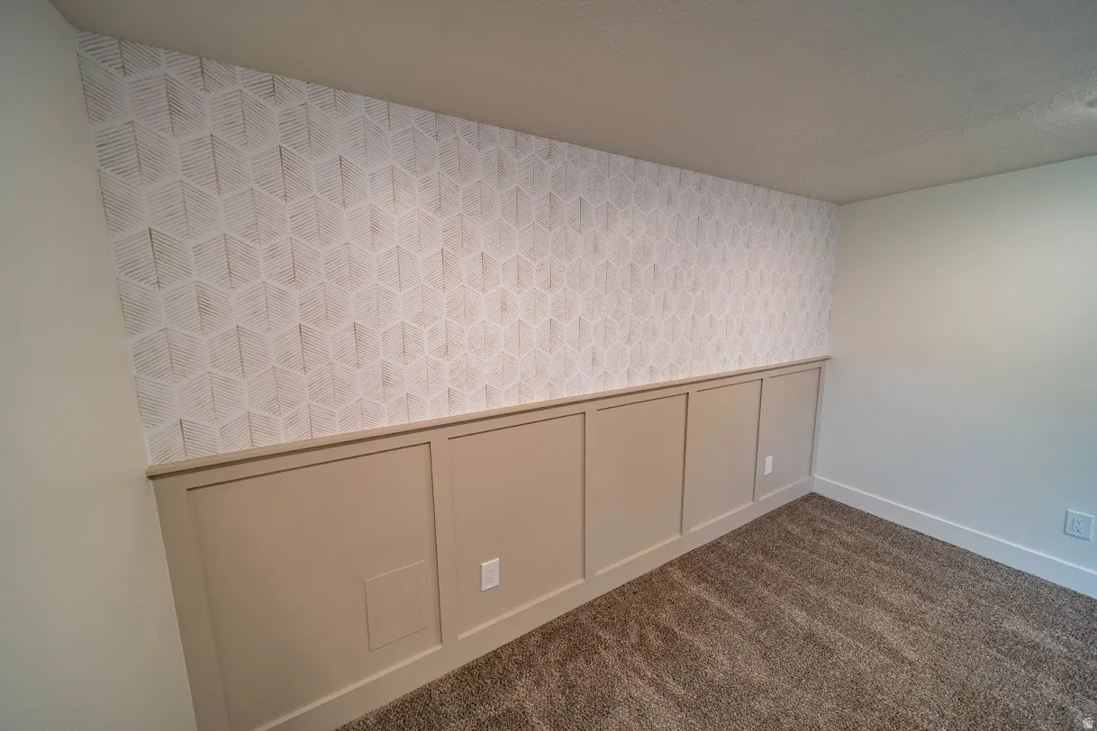 Geometric patterned accent wall with wainscoting detail