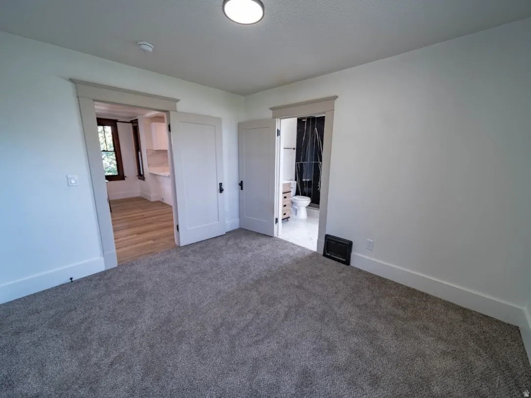 Spacious bedroom featuring neutral carpeting, recessed ceiling lighting, and multiple closet access points. third bedroom with connecting 3/4 bath.