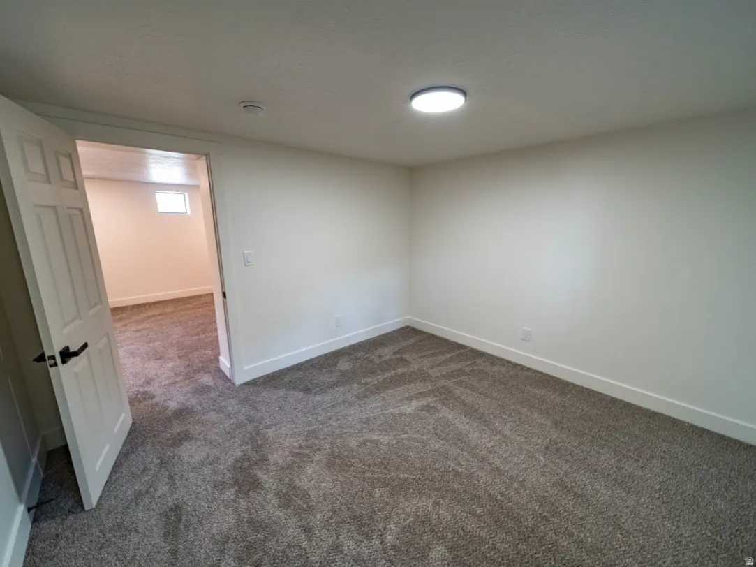Room featuring neutral wall finishes and patterned carpeting