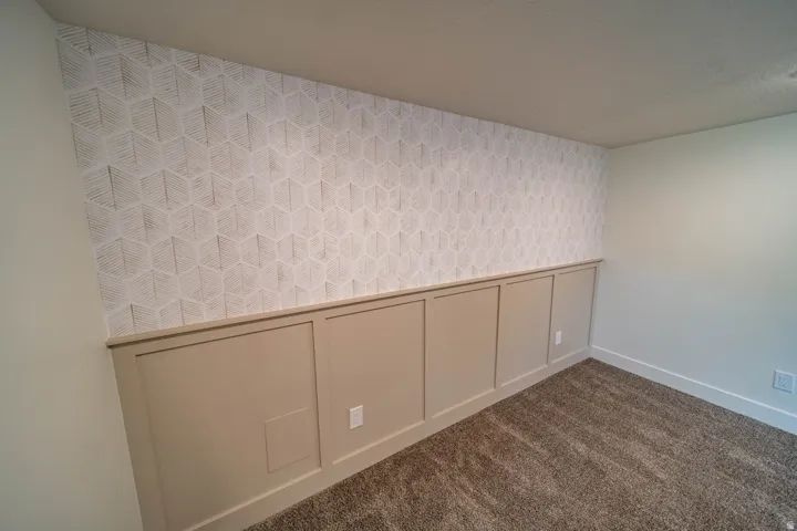 Geometric patterned accent wall with wainscoting detail