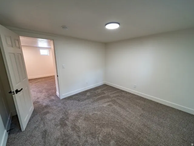 Room featuring neutral wall finishes and patterned carpeting