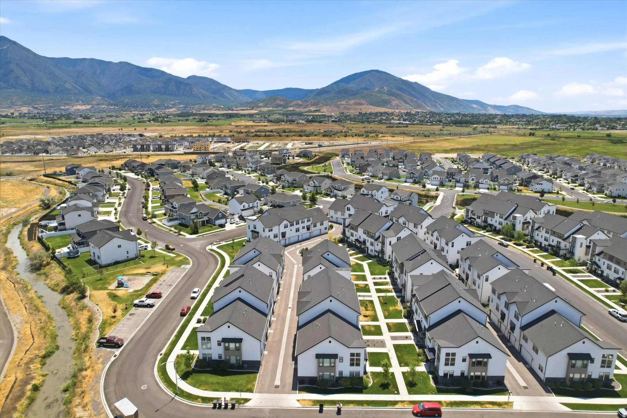 Expansive residential development featuring contemporary homes with dark-pitched roofs