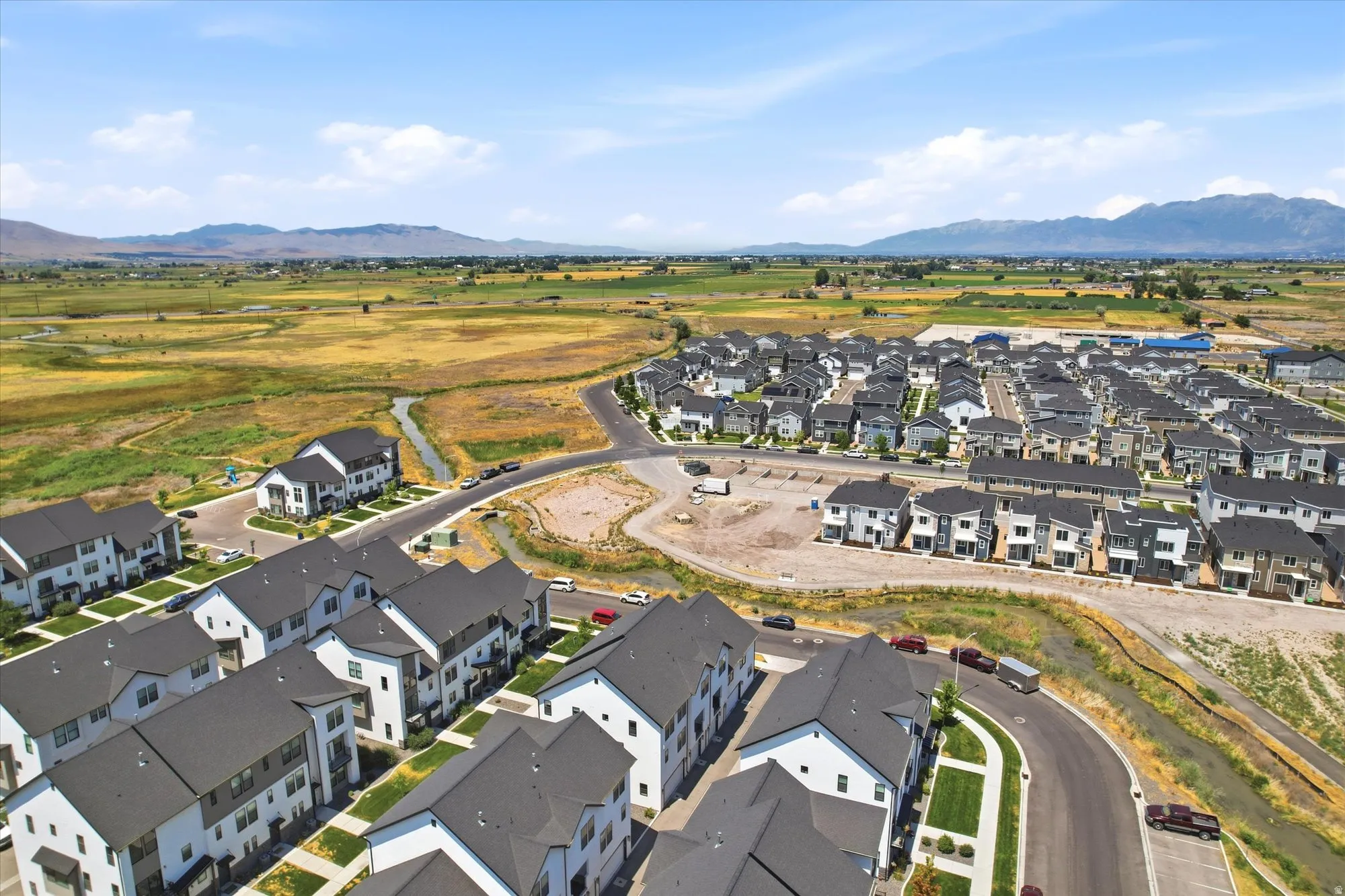 Aerial perspective of a developing residential community featuring a variety of multi-story homes