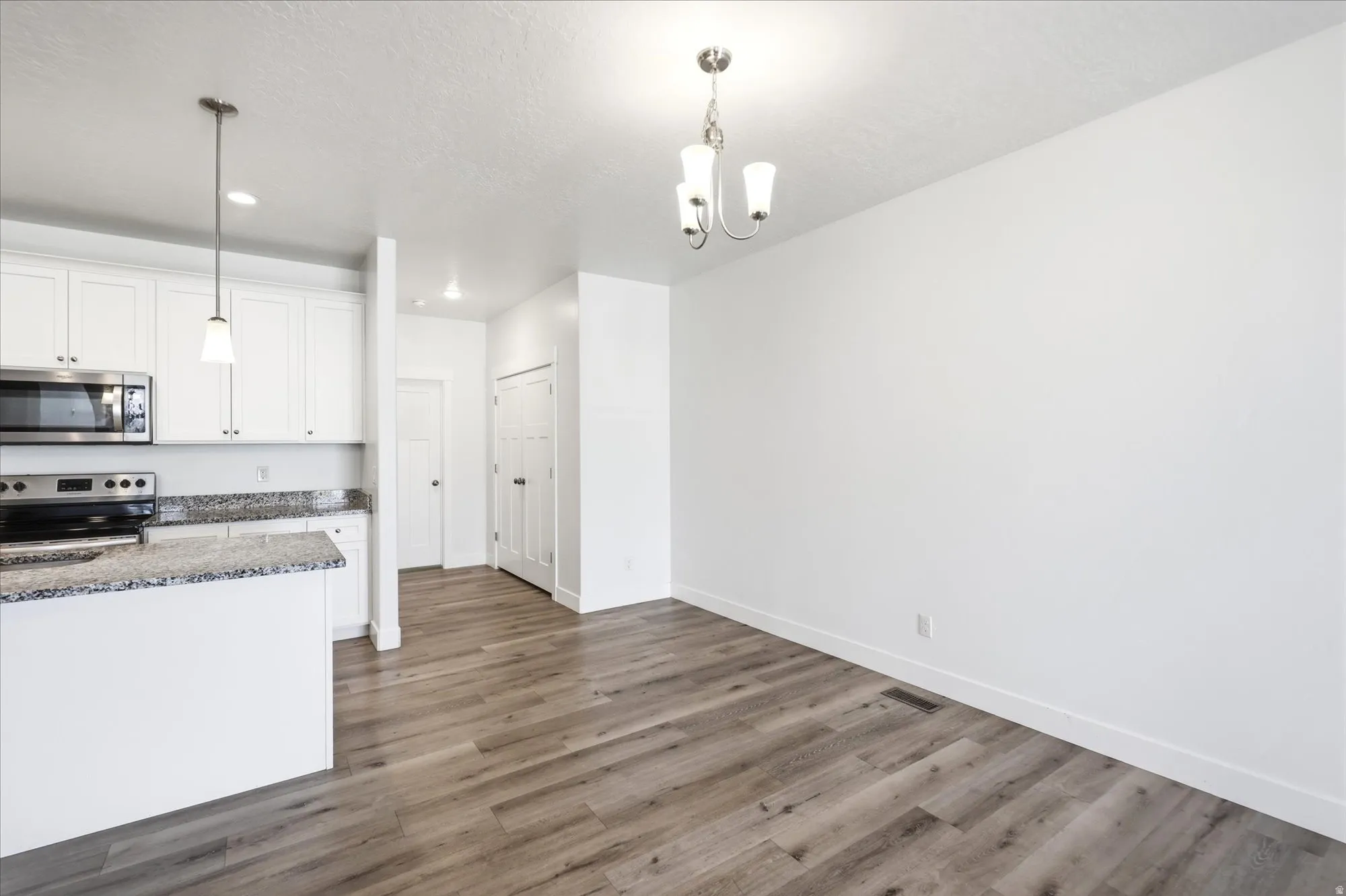 Open concept living space featuring wood-finish flooring