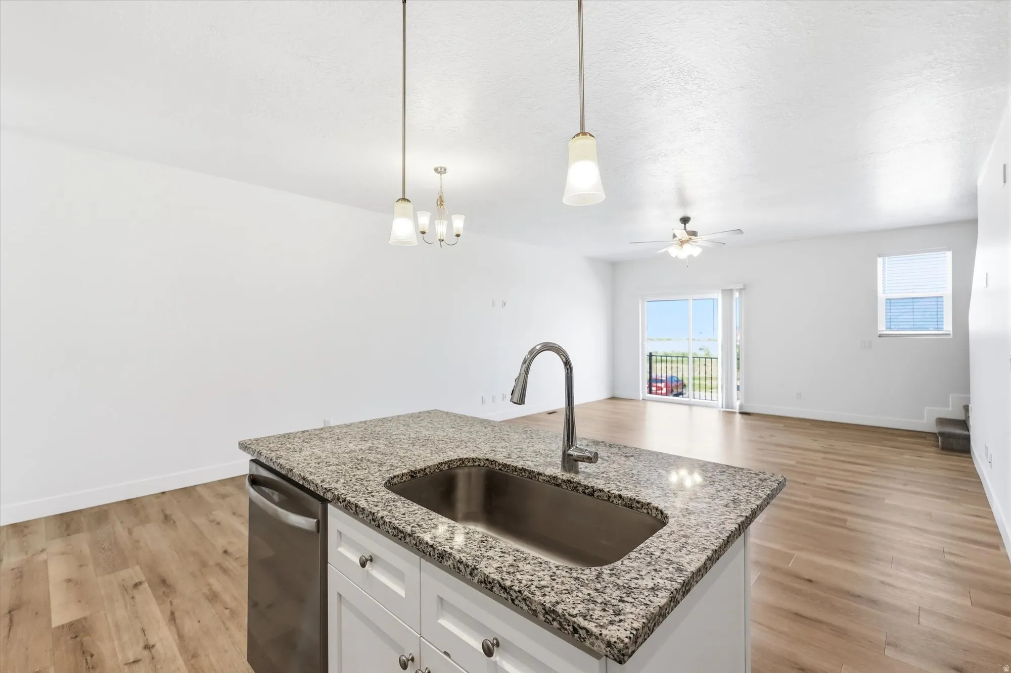 Kitchen island with granite countertop and stainless steel sink