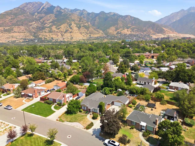 Mountain scenery encompassing a residential neighborhood with established trees