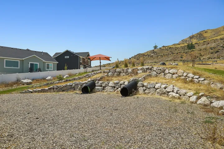 Expansive gravel area featuring terraced rock walls and integrated culverts